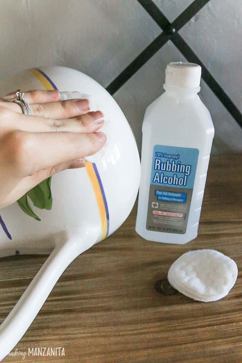 Cleaning the ceramic pitcher with a cotton round and rubbing alcohol