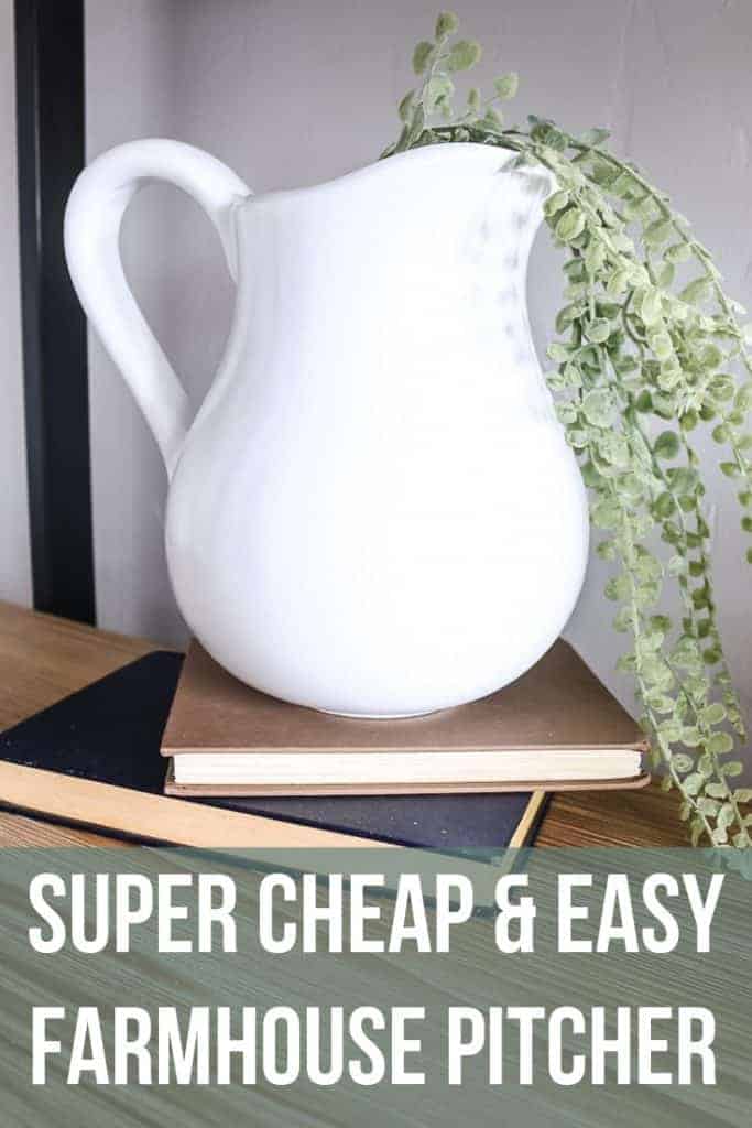 White farmhouse pitcher on stack of vintage books with faux greenery in it with text overlay that says super cheap and easy farmhouse pitcher