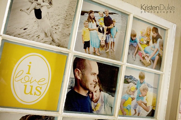 Vintage window used as a picture frame with family photos of kids having fun at the beach in them. One square of the frame says I love us with yellow background