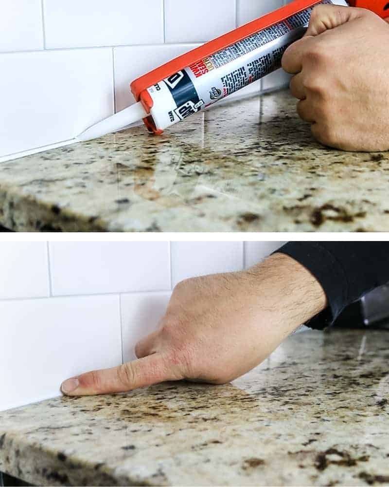 Applying DAP Kwik Seal Ultra caulking to the bottom of tile backsplash where the back splash meets the countertop and then smoothing the bead of caulk so it's flat.