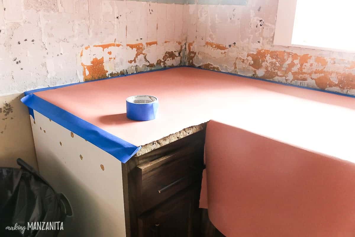 When installing a tile backsplash, you want to make sure the area is well prepped, with resin paper covering the countertop surfaces.