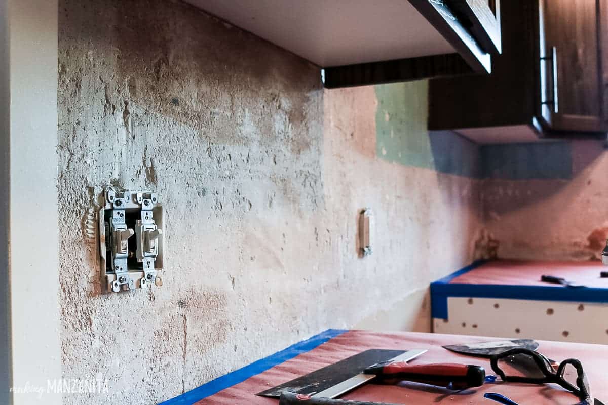 A closer look at a smooth kitchen wall after the tile backsplash was removed