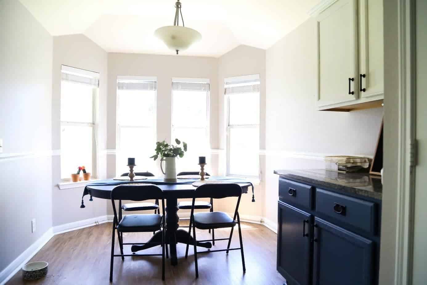 Dining room with bay windows, but lacking character before a DIY home renovation