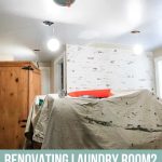 Laundry renovations in progress with washer and dryer and drop cloth in the middle of the room with text overlay that says renovating laundry room? Read this first