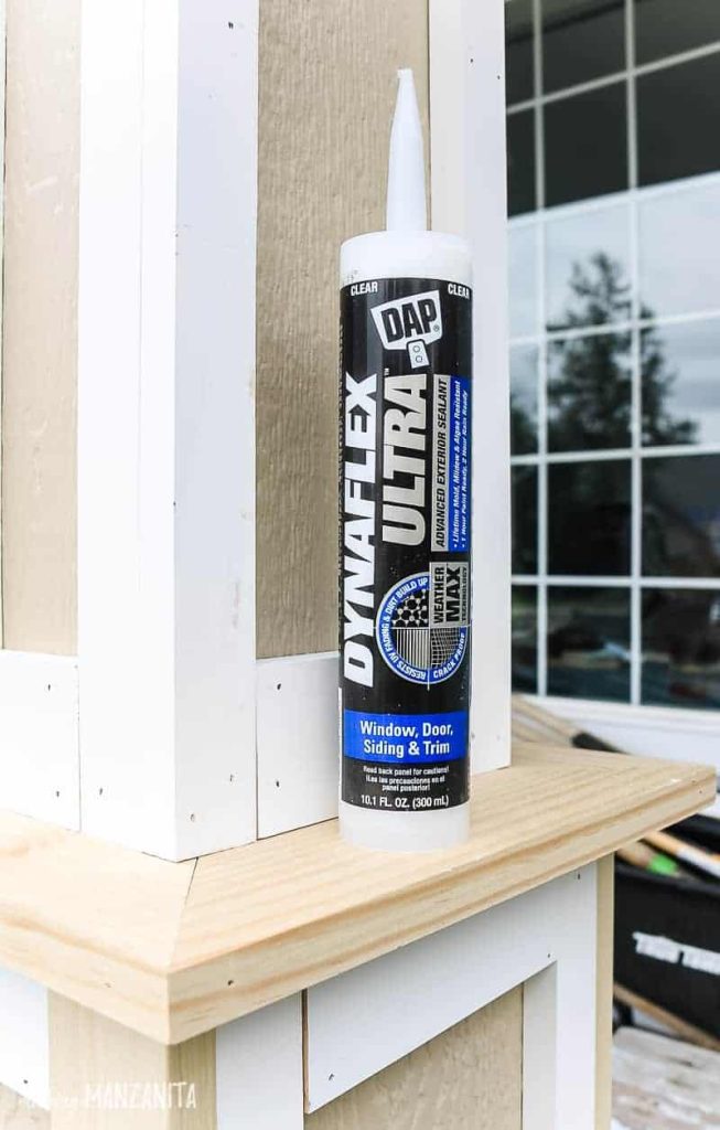 Bottle of DAP Dynaflex Ultra advanced exterior sealant sitting on the edge of the porch posts