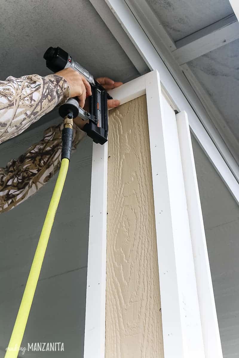 Nailing trim piece to the top of porch post 