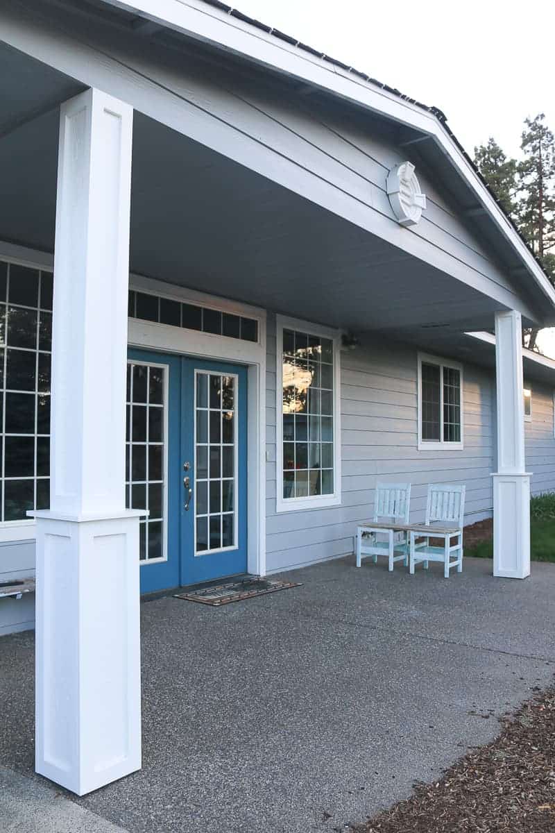 DIY porch posts with farmhouse style on a ranch style house painted blue