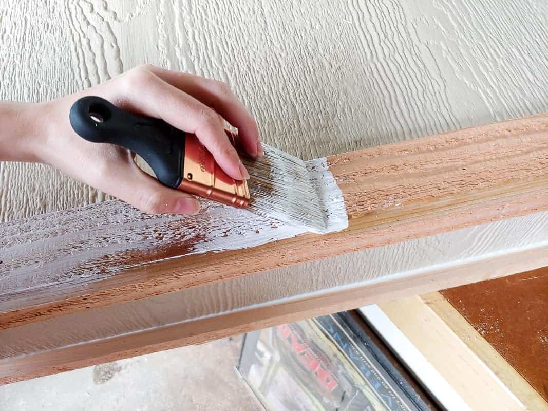 Using white exterior paint primer to paint the outdoor chalkboard box.