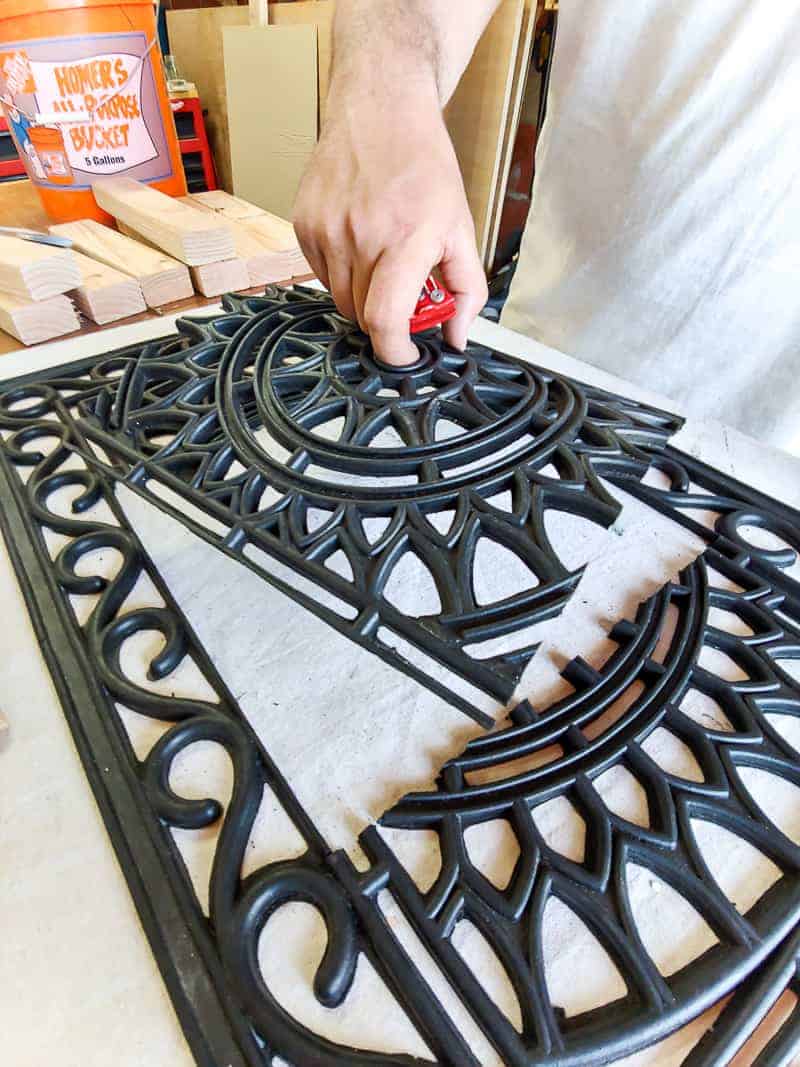 Cutting a rubber doormat down to size to fit the garden stepping stone mold