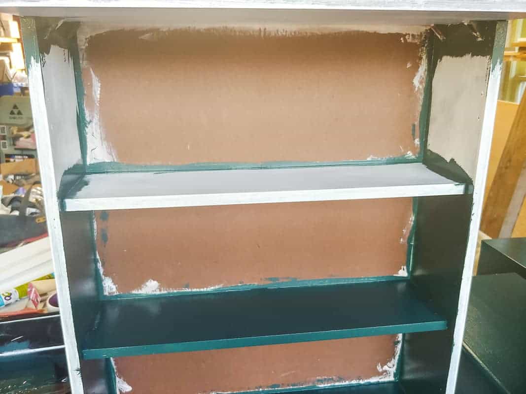 Half painted inside of the laminate cabinet makeover.