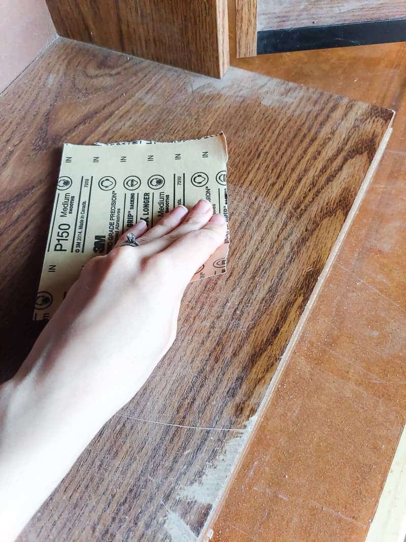 Sanding the inside of the laminated cabinet makeover before painting