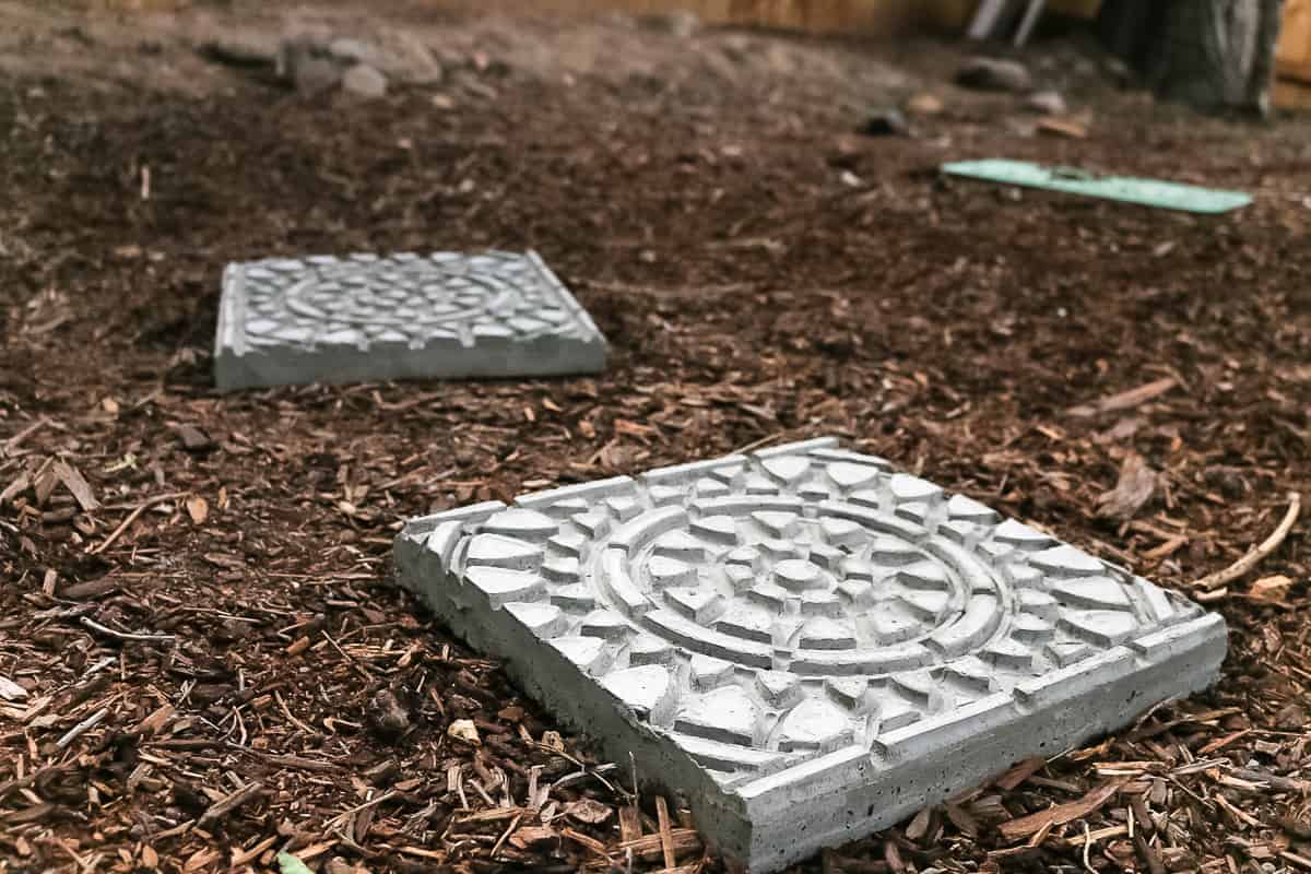 DIY concrete garden stepping stones sitting on top of garden mulch