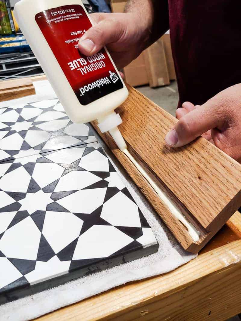 Applying wood glue to the wood in what to do with leftover tiles.