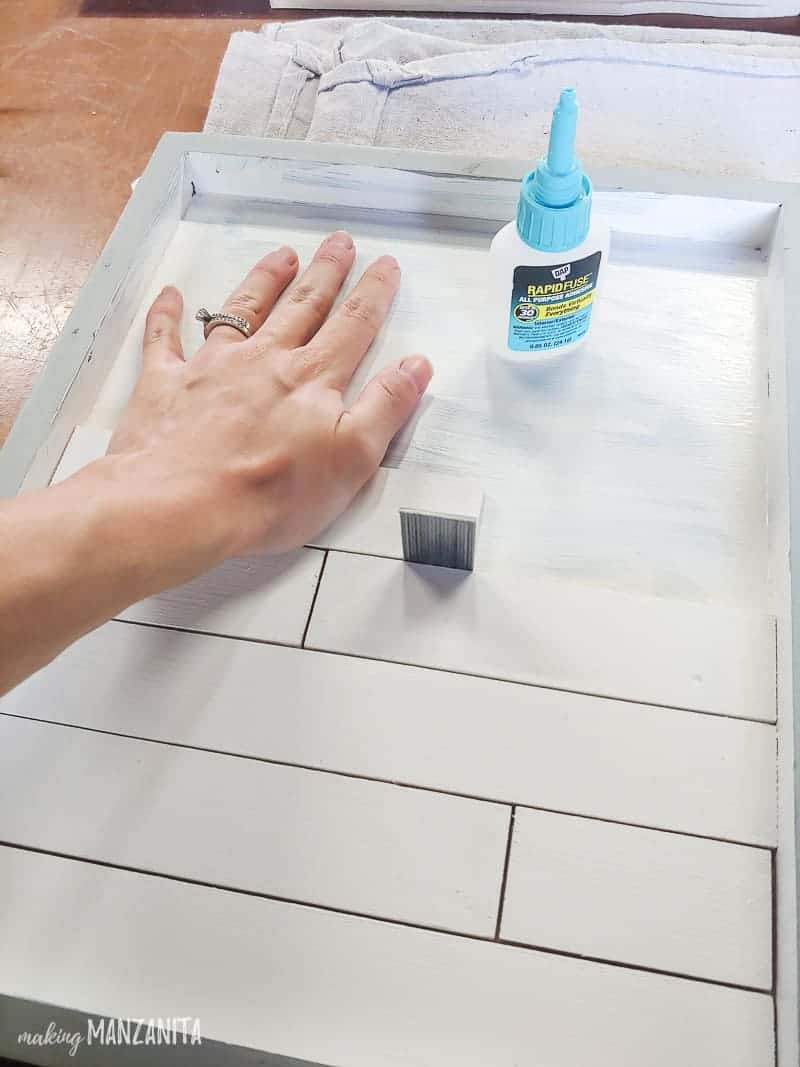 Attaching the mini shiplap on the frame and a glue at the side.