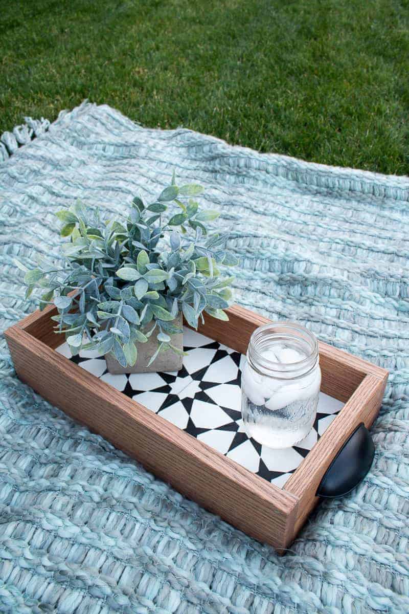 Finished diy serving tray with succulent and iced water on the blanket in what to do with leftover tiles.