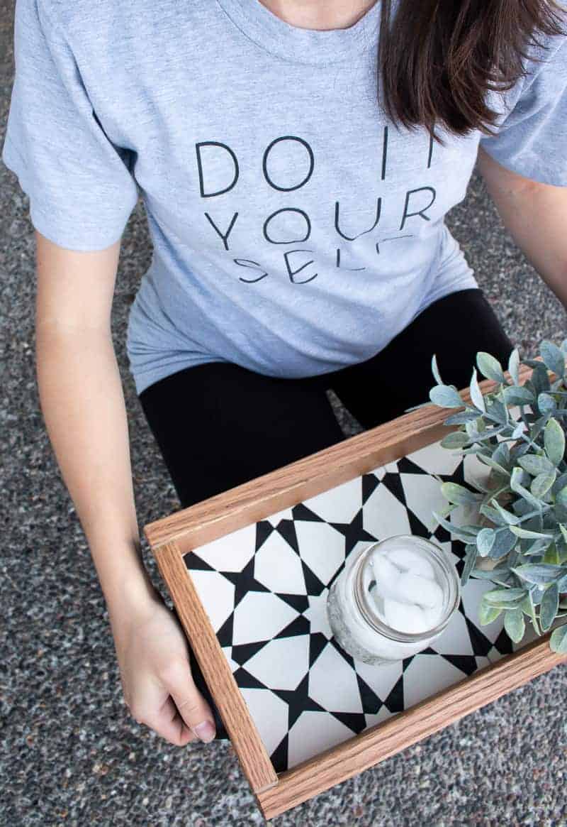 Woman holding the diy serving tray made with leftover tiles with succulent and ices water in what to do with leftover tiles