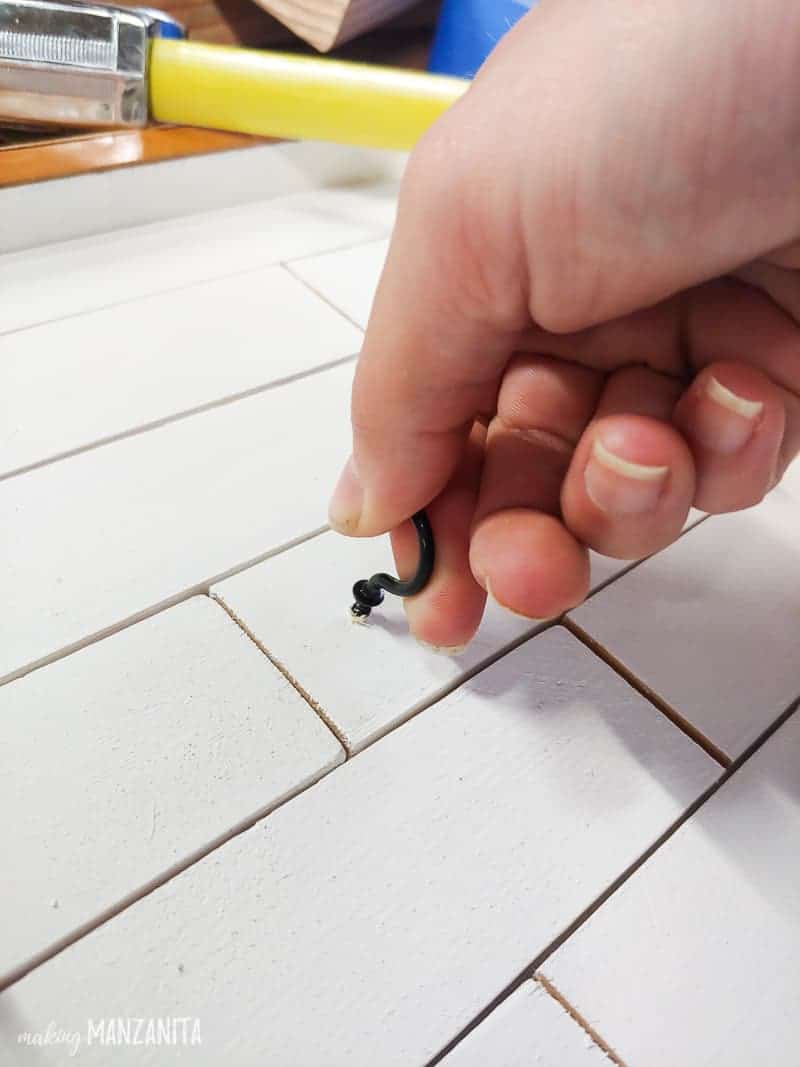Putting hooks on the shiplap for the DIY key holder