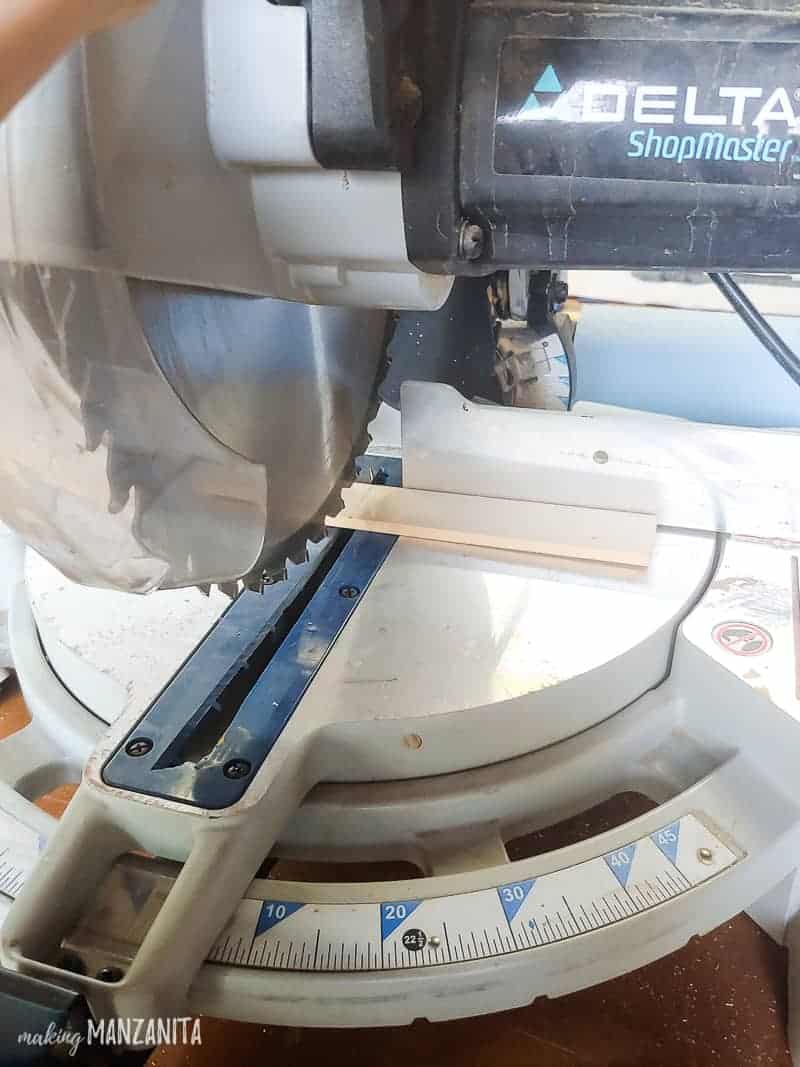 Use a miter saw to cut the paint sticks to create a faux shiplap design