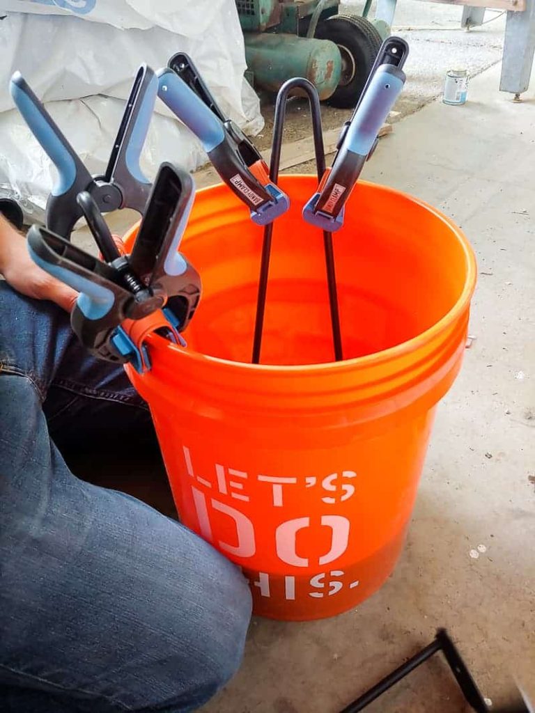 Hair pins legs clipped onto the bucket dipped in the concrete mix. to make a DIY concrete side table