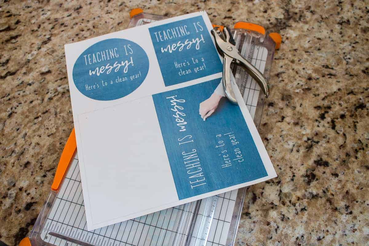 Printed out printable tags and card for teacher gift that says Teaching is messy, here's to a clean year ! sitting on counter