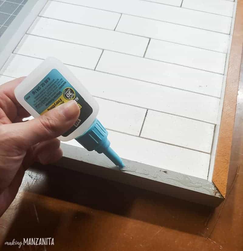 Applying glue to the frame to attach the leather strips