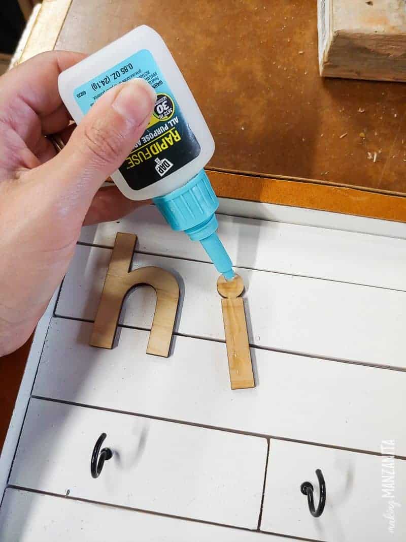 Putting glue at the back of the letters with DAP Rapid Fuse to create a cute farmhouse style key holder sign