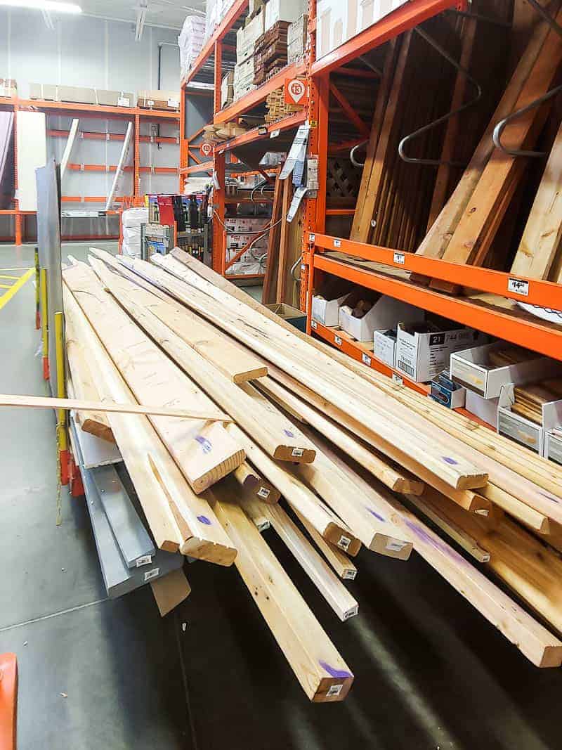 Pile of lumber in the cull lumber section at Home Depot, to be used to make our DIY planter box for the front porch.