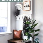 Entryway design which includes coat racks, key holder, leather pillow, wooden bench, wooden shoe storage and indoor plant with text overlay that says Small Corner Entryway