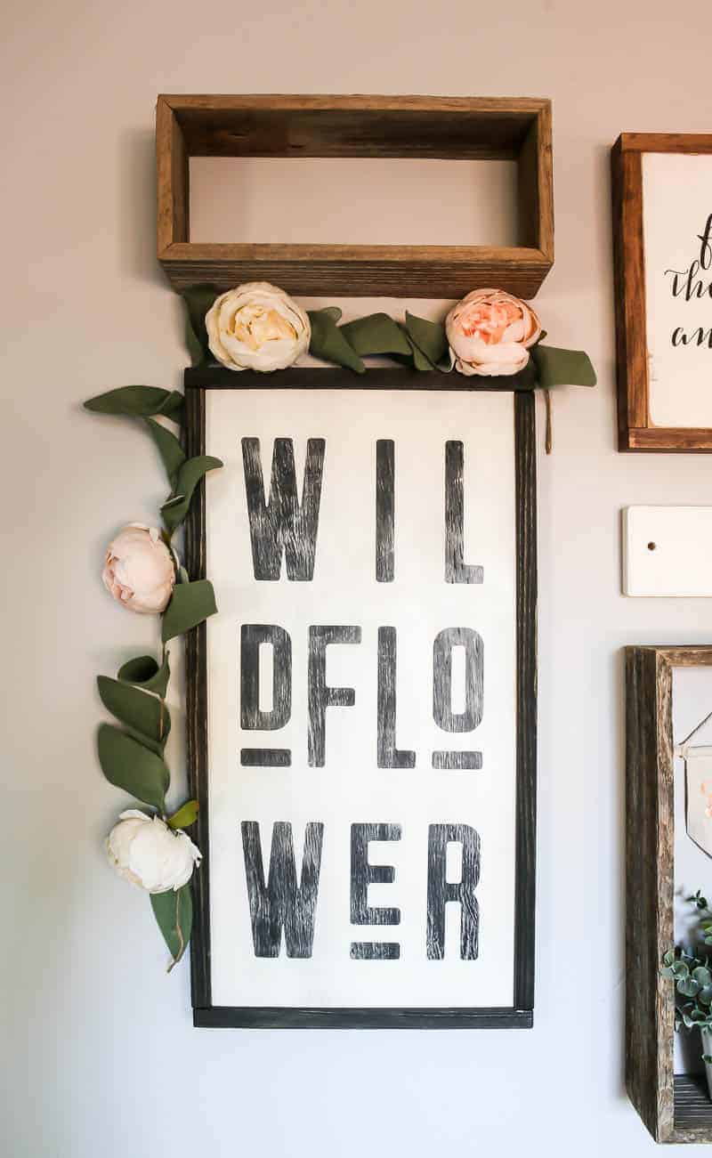 This wildflower wall art is part of our baby girl nursery gallery wall. We added a vine of faux flowers around the frame.