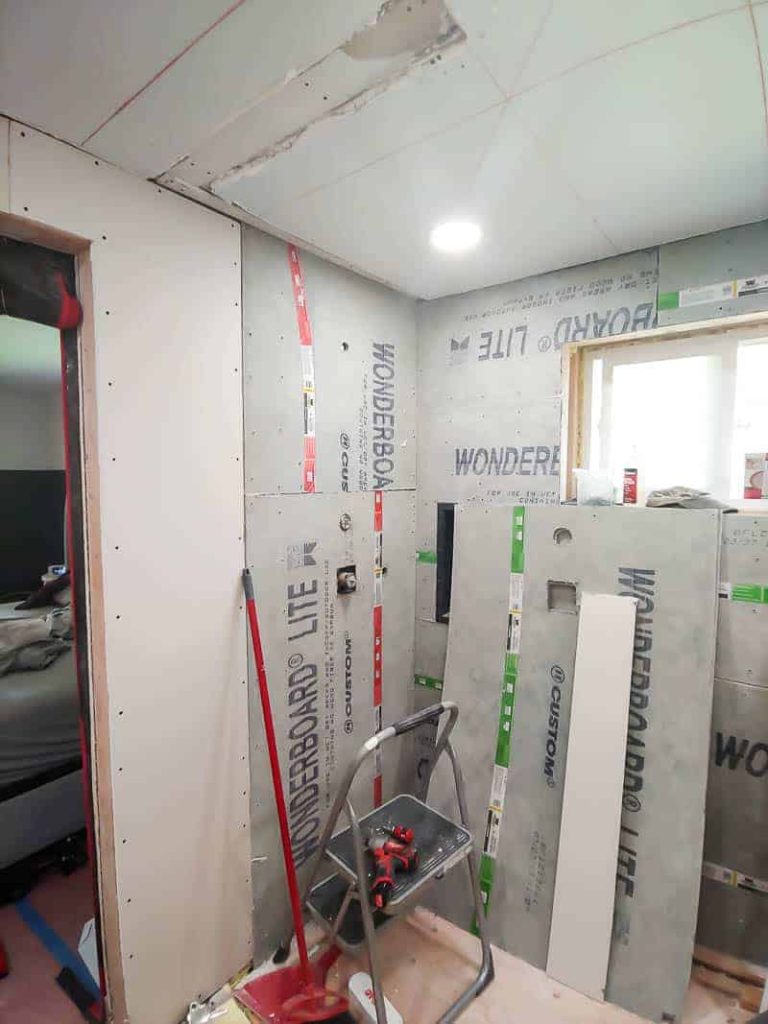 A photo of shower installation in progress with walls made from WonderBoard.