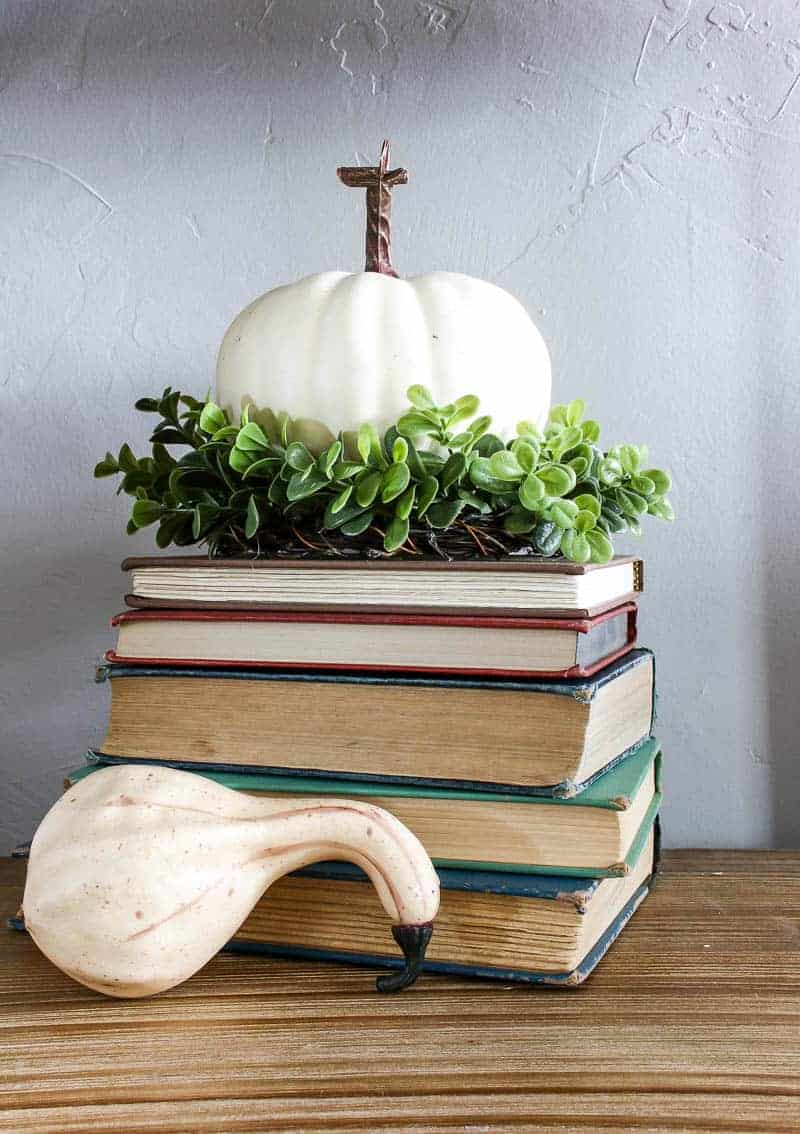 Add some stacked books, gourds and pumpkins, and some greenery to your Living Room Shelf Decor for fun fall vibes in your living room.