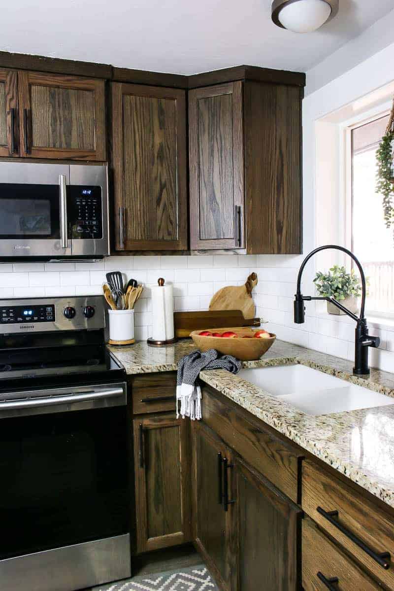 Farmhouse kitchen with the new undermount sink and the black faucet.