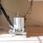 Sanding the cheap hardwood flooring