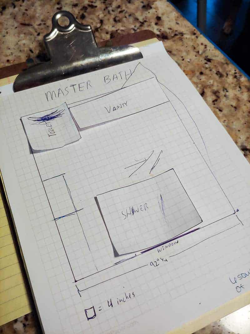 The plan for our master bathroom renovation, sketched out on graph paper, detailing where to place the toilet, vanity, and shower.