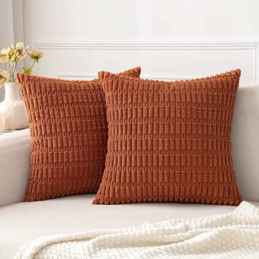 Fall themed throw pillows make inexpensive fall decorations.