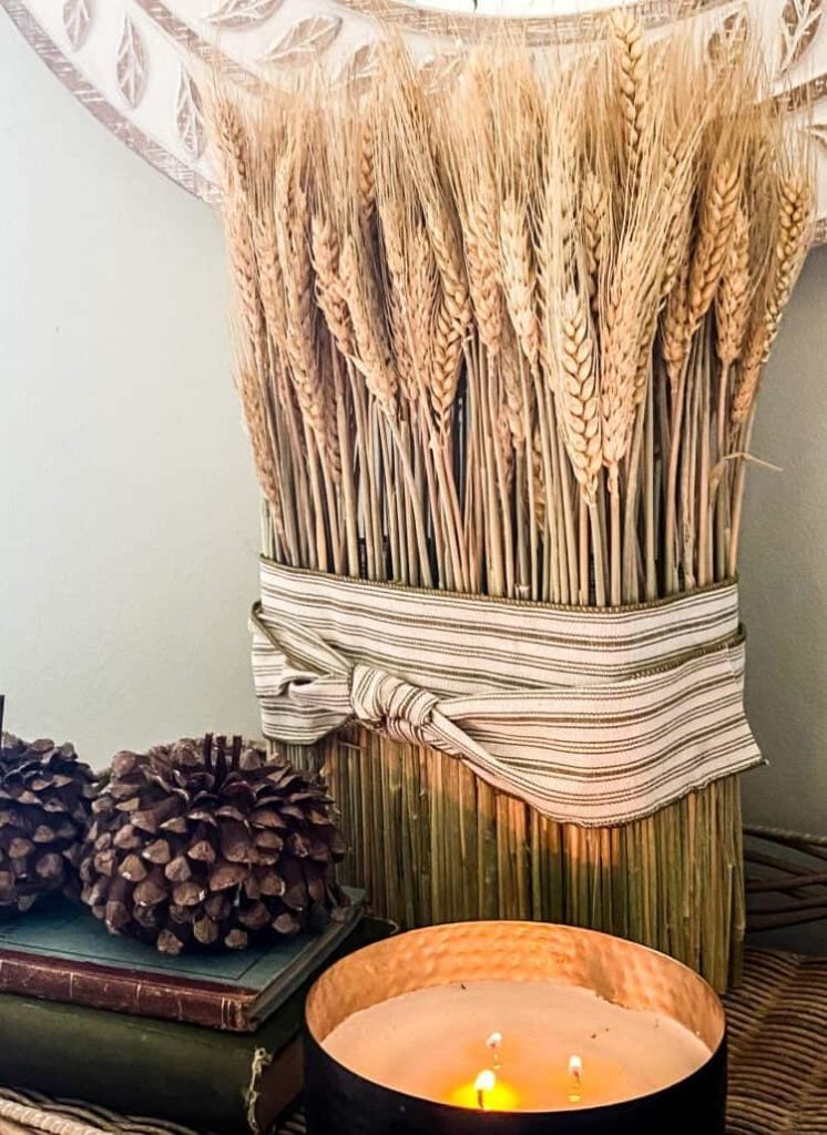 An inexpensive fall decorating idea is to make a centerpiece using floral foam, wheat and dried pine cones. Explore our creative and affordable autumn decor ideas.