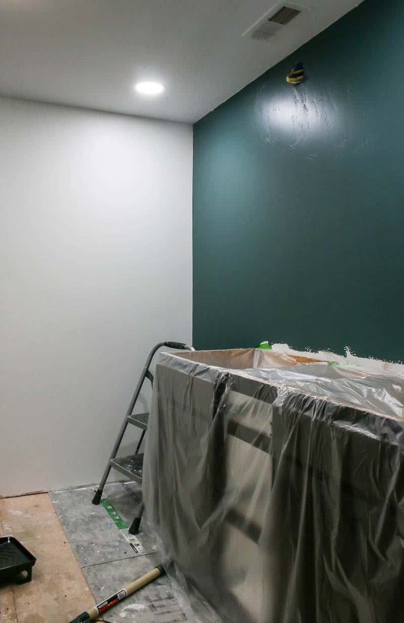 Dark hunter green feature wall in bathroom during an ensuite bathroom remodel