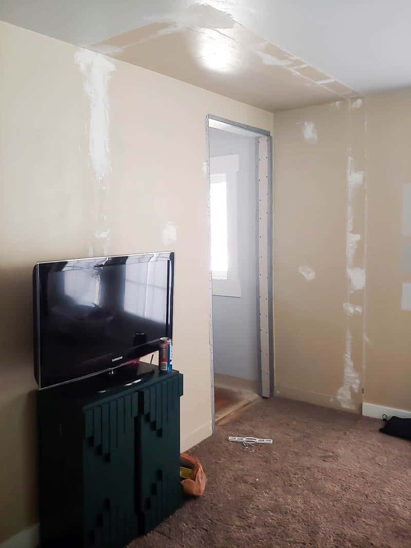 The entrance to our master bedroom, with unfinished paint and torn up walls.