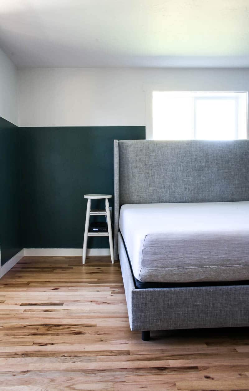 Perfectly painted straight lines on our two tone bedroom walls, the top part of the walls are white, the lower part is painted a deep jade green.