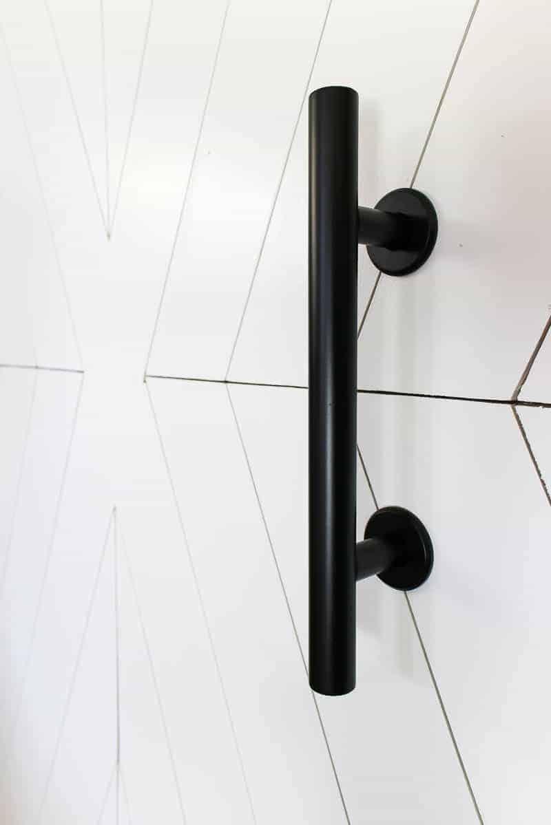 A close up image of the modern industrial barn door handle and x design.