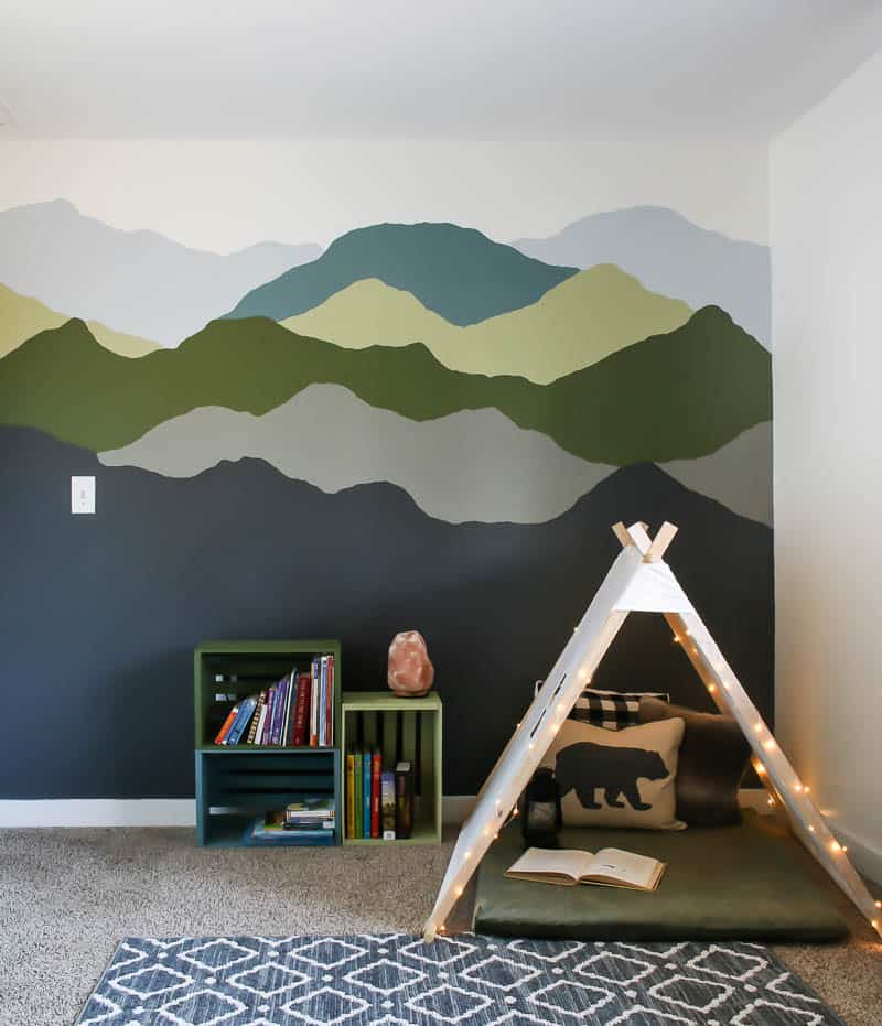 Behr Graphic Charcoal painted on bottom of mountain mural in kid's space with a nature inspired color palette 