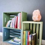 Mountain mural behind the painted wooden crate bookshelf