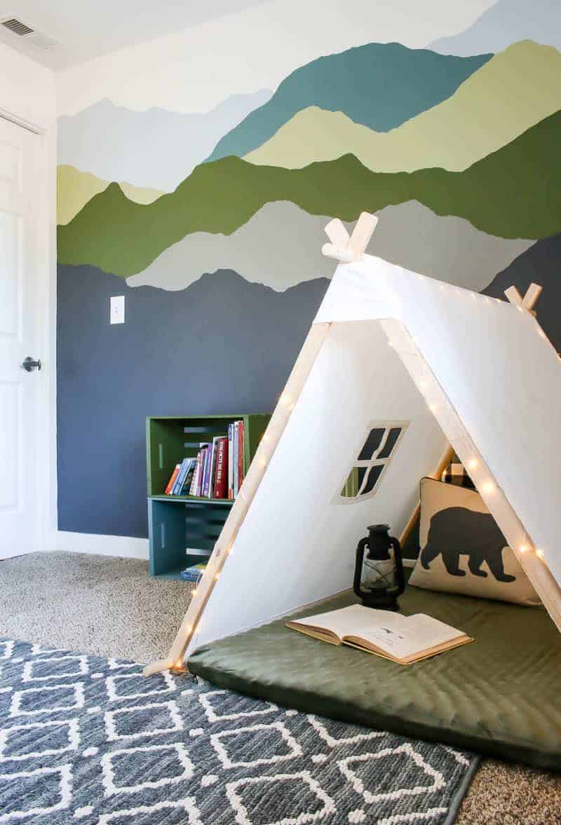 woodland boys room with painted wall cozy nook and colorful pallet bookshelves