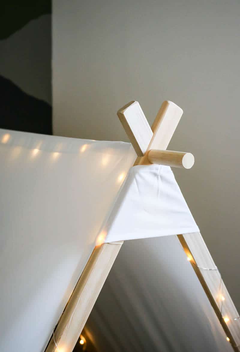 Upper part of the wooden nook made out a teepee tent with lights added for a boy's toddler room