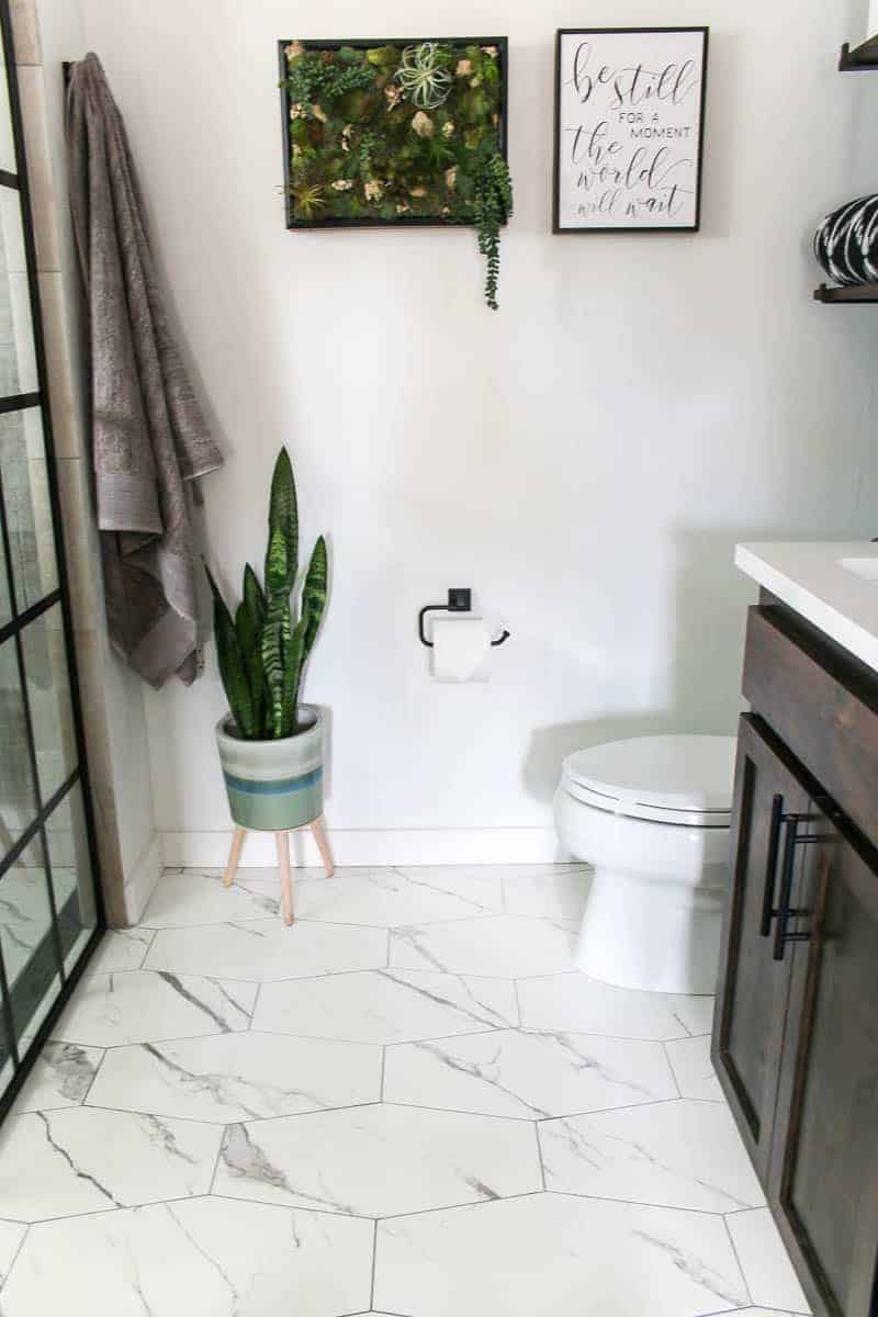 Wall decor, toilet bowl, bath towels, indoor plant for the new modern bathroom reveal