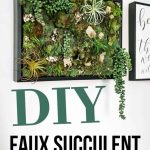 Green succulent wall art with air plants and moss hanging on a white wall with text overlay that says DIY faux succulent vertical garden