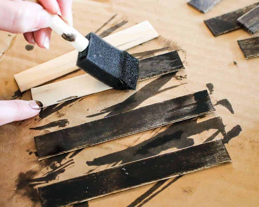 Staining Popsicle sticks using a foam paint brush 