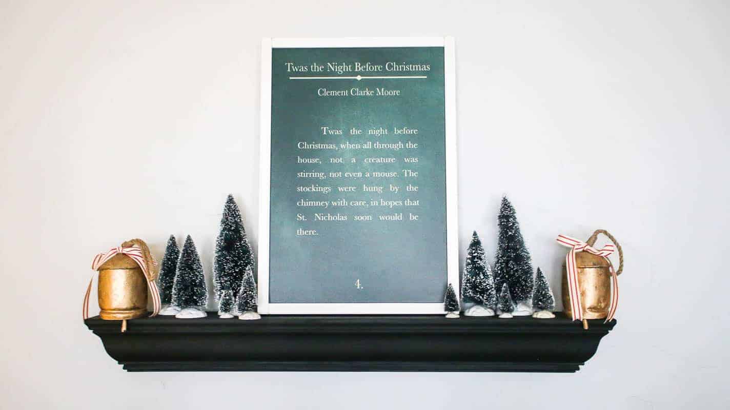 Night Before Christmas farmhouse style sign styled on a floating shelf with other Christmas decor like vintage bells and mini vintage bottle brush Christmas trees