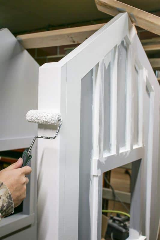 Priming and painting panels for DIY bed for kid's room that looks like a house with windows 