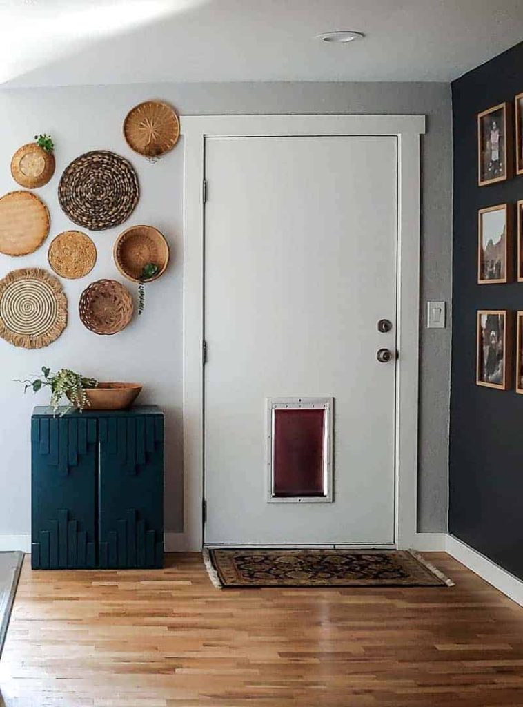 A boho-inspired entry way with a wicker basket wall, created with different size, shape, and color wicker baskets